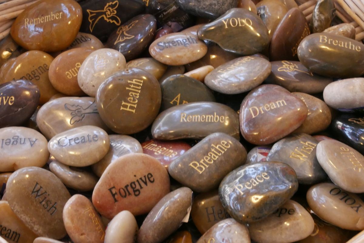 Inner balance concept, brown stone with word, health, remember, forgive, peace,create, wish, breath, dream